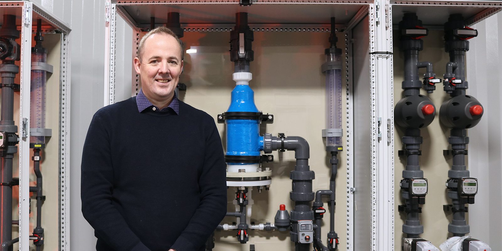 Scotmas CEO, Alistair Cameron, in front of some Scotmas’ advanced water disinfection equipment.
