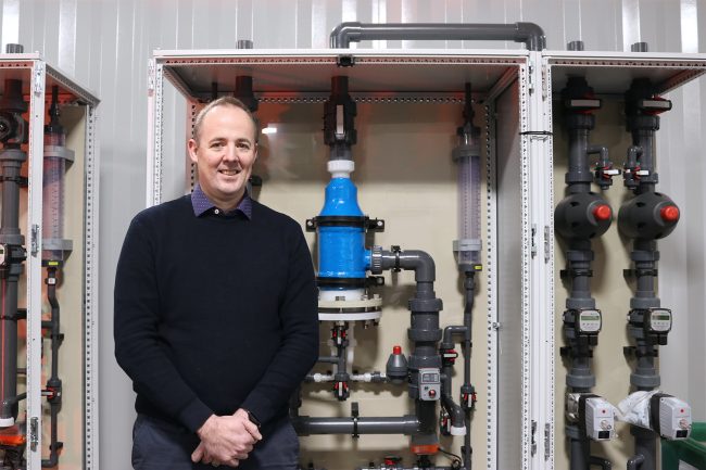 Image One Scotmas CEO, Alistair Cameron, in front of some Scotmas’ advanced water disinfection equipment.