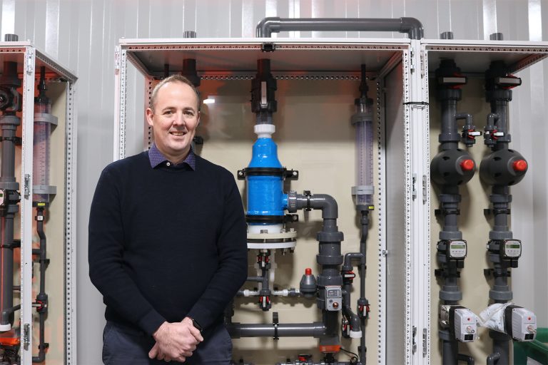 Image One Scotmas CEO, Alistair Cameron, in front of some Scotmas’ advanced water disinfection equipment.