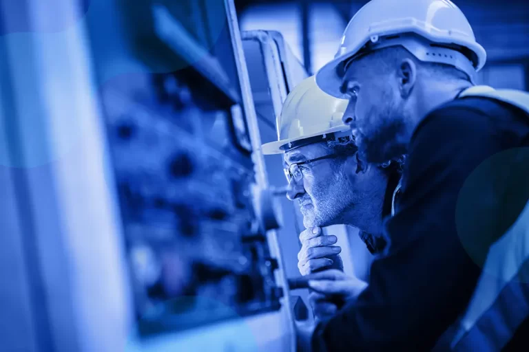 Two engineers looking at a system